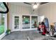 Sunroom with tiled floor, windows, door to outside, and golf equipment at 981 Sherwood Cir, Lancaster, SC 29720