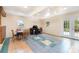 Finished basement area with unique tile flooring, dining space, and a functional workspace at 103 Sadler Rd, Mount Holly, NC 28120