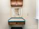 Bathroom vanity with wood cabinets, light countertop and blue tile at 103 Sadler Rd, Mount Holly, NC 28120