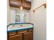 Bathroom vanity with wood cabinets, light countertop and blue tile at 103 Sadler Rd, Mount Holly, NC 28120
