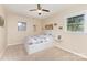 Comfortable bedroom with a patterned comforter, neutral walls, and a ceiling fan at 103 Sadler Rd, Mount Holly, NC 28120