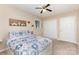 Comfortable bedroom with a patterned comforter, neutral walls, and a ceiling fan at 103 Sadler Rd, Mount Holly, NC 28120