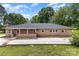 Charming brick home with a classic design and mature trees creating a serene and inviting atmosphere at 103 Sadler Rd, Mount Holly, NC 28120