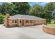Charming brick home featuring a front porch and driveway at 103 Sadler Rd, Mount Holly, NC 28120