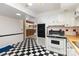 This kitchen features white appliances, black and white flooring, and a wood countertop at 103 Sadler Rd, Mount Holly, NC 28120
