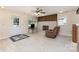 Cozy living area featuring a brick fireplace, a comfortable recliner, and plenty of natural light at 103 Sadler Rd, Mount Holly, NC 28120