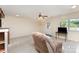 Spacious living room featuring plush carpet, natural light, and a ceiling fan at 103 Sadler Rd, Mount Holly, NC 28120