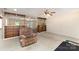 Comfortable living area with a cozy recliner and seamless flow to additional living spaces at 103 Sadler Rd, Mount Holly, NC 28120