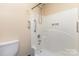 A shower with white tile and handicap bars at 103 Sadler Rd, Mount Holly, NC 28120