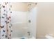 Shower featuring a white shower insert with shower head and handle, and a colorful butterfly patterned shower curtain at 103 Sadler Rd, Mount Holly, NC 28120
