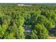 An aerial view displays the home nestled among lush, green trees and a well-manicured landscape at 1055 Cedar Hill Dr, Rockwell, NC 28138