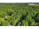 An aerial view displays the home nestled among lush, green trees and a well-manicured landscape at 1055 Cedar Hill Dr, Rockwell, NC 28138
