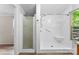 Bathroom featuring a walk-in shower and a large window at 1055 Cedar Hill Dr, Rockwell, NC 28138