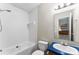 Bathroom with a tub and shower, white toilet, vanity with blue countertop, and large mirror at 1055 Cedar Hill Dr, Rockwell, NC 28138