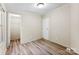 Bedroom featuring wood-look flooring, two closets, and a window providing natural light at 1055 Cedar Hill Dr, Rockwell, NC 28138