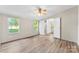 Bright bedroom featuring new flooring, a ceiling fan, and ensuite bathroom access at 1055 Cedar Hill Dr, Rockwell, NC 28138