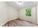 Bedroom with wood-look flooring and bright natural light from the window at 1055 Cedar Hill Dr, Rockwell, NC 28138