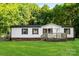 Charming single-story home featuring a spacious front lawn and inviting wooden deck at 1055 Cedar Hill Dr, Rockwell, NC 28138