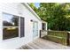The house features a wooden deck and a white exterior with black shutters, offering a welcoming facade at 1055 Cedar Hill Dr, Rockwell, NC 28138