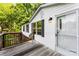 The house features a wooden deck and a white exterior with black shutters, offering a welcoming facade at 1055 Cedar Hill Dr, Rockwell, NC 28138