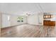 Spacious living room with wood-look flooring, neutral walls, and a doorway to the kitchen at 1055 Cedar Hill Dr, Rockwell, NC 28138