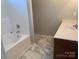 Bathroom with a white tub and marbled tile floors at 11622 Lioness St, Charlotte, NC 28273