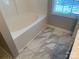 Bathroom with tub and marbled tile at 11622 Lioness St, Charlotte, NC 28273