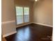 Cozy bedroom features hardwood floors, neutral walls, and a large window at 11622 Lioness St, Charlotte, NC 28273