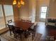 Open dining room with a large wooden table, six chairs, and an area rug at 11622 Lioness St, Charlotte, NC 28273