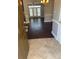 Open entryway featuring tile transitioning to dark hardwood flooring and view of living room at 11622 Lioness St, Charlotte, NC 28273
