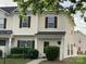 Charming two-story townhome with light siding, dark shutters, and well-maintained landscaping at 11622 Lioness St, Charlotte, NC 28273