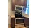 The updated kitchen boasts a modern range, microwave, and dark cabinets at 11622 Lioness St, Charlotte, NC 28273