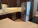 Well-lit kitchen with stainless steel appliances, dark wood cabinets, and plenty of counter space at 11622 Lioness St, Charlotte, NC 28273