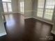 Bright living area with dark hardwood floors, neutral paint, and view of the back yard at 11622 Lioness St, Charlotte, NC 28273