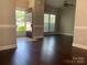 Bright living room featuring dark wood floors and a ceiling fan at 11622 Lioness St, Charlotte, NC 28273
