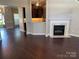 Open-concept living room with hardwood floors, fireplace, and view of the kitchen at 11622 Lioness St, Charlotte, NC 28273