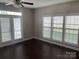 Sunlit living room featuring hardwood floors and large windows at 11622 Lioness St, Charlotte, NC 28273