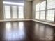 Light filled living space featuring hardwood floors, light neutral walls, and bright french doors at 11622 Lioness St, Charlotte, NC 28273