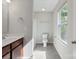 Neutral-toned bathroom features a single sink vanity, ceramic tile floors, and a window with verdant outdoor views at 1175 Valley St # 111, Statesville, NC 28677