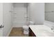 Well-lit bathroom features a shower and tub combo, a cherry cabinet, and a standard toilet at 1175 Valley St # 111, Statesville, NC 28677