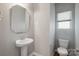 Powder room features a pedestal sink, an octagon mirror, a single window, and a standard toilet at 1175 Valley St # 111, Statesville, NC 28677