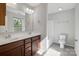 Bright bathroom features a double sink vanity, neutral color scheme, and a tub and shower combination at 1175 Valley St # 111, Statesville, NC 28677
