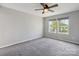 This bedroom features carpet floors, light gray walls, a ceiling fan, and two windows at 1175 Valley St # 111, Statesville, NC 28677