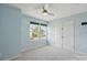 Light blue bedroom features carpet floors, a ceiling fan, two windows, and a closet with double doors at 1175 Valley St # 111, Statesville, NC 28677