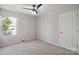 This cozy bedroom features a window and a door, has carpet flooring, and is painted in a neutral color at 1175 Valley St # 111, Statesville, NC 28677