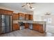 Well-lit kitchen features stainless steel appliances, wooden cabinets, granite countertops, and hardwood floors at 1175 Valley St # 111, Statesville, NC 28677