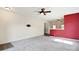 Open-concept living room flows into kitchen area, featuring neutral carpet and ceiling fan at 1175 Valley St # 111, Statesville, NC 28677