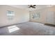Bright living room featuring neutral carpeting, modern ceiling fan, and ample natural light at 1175 Valley St # 111, Statesville, NC 28677