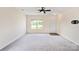 Bright living room featuring neutral carpeting, modern ceiling fan, and ample natural light at 1175 Valley St # 111, Statesville, NC 28677