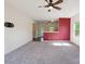 Open-concept living room flows into kitchen area, featuring neutral carpet and ceiling fan at 1175 Valley St # 111, Statesville, NC 28677